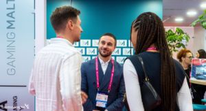Representatives speaking with delegates at the Make It in Malta booth during SBC Summit Lisbon 2026.